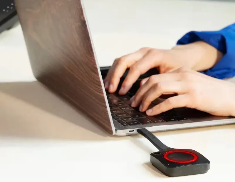 Clickshare dongle attached to a laptop - all Motor Hub Warwick meeting rooms use Clickshare technology